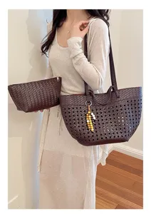 Detail view of stylish brown woven leather tote bag with matching pouch and bead charm.