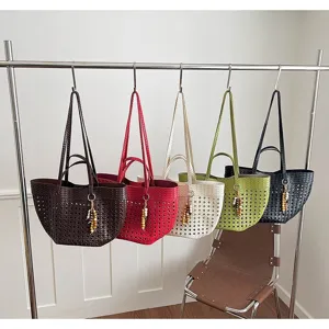 Detailed view of large capacity woven tote bags hanging on rack, multi-color casual daily use.