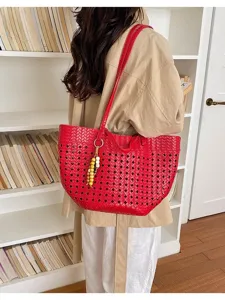 Red woven tote bag detail, cutout design, stylish leather shoulder bag with wooden bead charm.