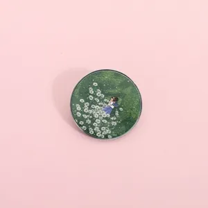 Broche ronde en métal avec illustration anime dans un champ de jolies fleurs marguerites blanches.