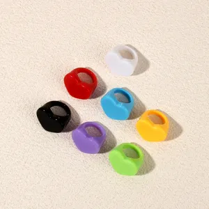 Colorful acrylic heart shaped rings detail shot showcasing multiple vibrant colors.