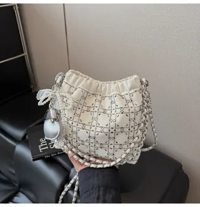 Fashion white rhinestone bucket bag with chic chain strap and pearl lace pendant.