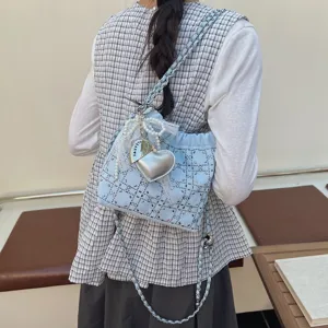 Chic light blue bucket bag with chain strap, rhinestones, pearl bow and heart shaped charm.
