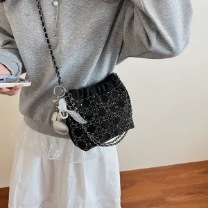 Black quilted chain bucket bag for women, stylish crossbody shoulder bag with metal studs.
