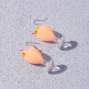 Cute resin juice cup dangle earrings with lemon slice and straw detail, playful summer beach style.