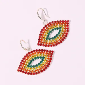 Detailed view of colorful rhinestone lip pendant hook earrings, fashion statement jewelry.