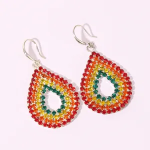 Detailed close-up shot of vibrant teardrop dangle earrings featuring colorful crystal pave.