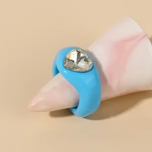 Closeup of the blue acrylic chunky ring with a sparkly heart rhinestone detail on cone prop.