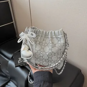 Silver rhinestone chain bucket bag with pearl bow pendant, elegant chic shoulder bag for women.