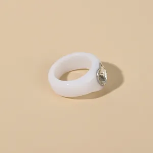 Chic white acrylic heart ring with sparkling rhinestone detail, minimalist fashion jewelry.