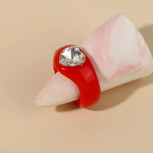 Detailed shot of a red acrylic heart rhinestone ring, stylish resin chunky ring for women.