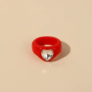 Chunky red resin ring with clear rhinestone heart, minimalist acrylic fashion jewelry for women.