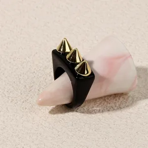 Black acrylic punk ring featuring three gold-tone cone spikes for edgy daily fashion.