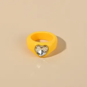Acrylic heart rhinestone ring detail closeup, trendy yellow chunky statement ring for women.