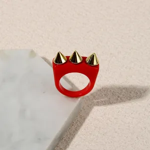Red acrylic punk ring with gold tone metal spikes, bold statement fashion jewelry for women.