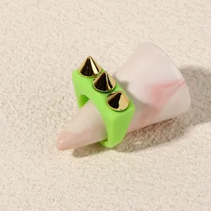 Detailed close-up view of a neon green acrylic punk ring featuring three gold-tone metal spikes.