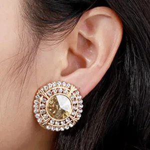 Gold crystal flower stud earrings with sparkling rhinestones, elegant vintage fashion jewelry.