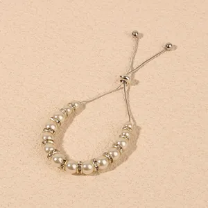 Adjustable pearl rhinestone bracelet detail view, elegant silver tone beaded charm jewelry.
