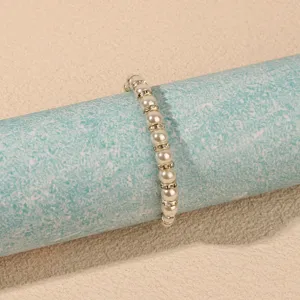 Elegant pearl and rhinestone beaded bracelet, sparkling crystal accents for women. Detail view.