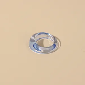 Minimalist transparent blue acrylic ring for women, simple resin finger jewelry detail view.