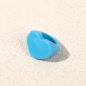 Close-up of blue heart acrylic ring, stylish resin knuckle ring for daily wear and party.