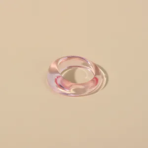 Close-up detail shot of a minimalist transparent pink acrylic resin ring, sleek and modern.