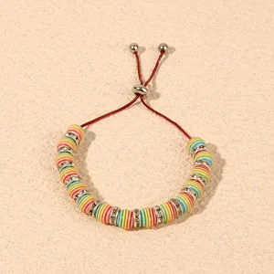 Detailed close-up shot of colorful striped beaded adjustable bracelet with rhinestones.