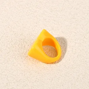 Minimalist yellow heart acrylic ring, stylish resin geometric finger ring detail view.