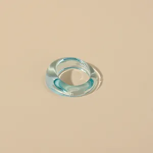 Transparent light blue acrylic chunky ring detail view, modern minimalist resin jewelry design.