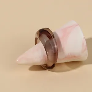 Detail view of a stylish translucent dark brown acrylic ring, minimalist resin fashion jewelry.