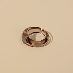 Detailed close-up view of a minimalist translucent brown acrylic resin ring with smooth polished finish.