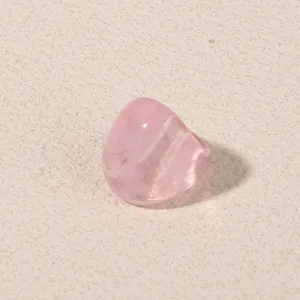 Close-up of a pink translucent geometric acrylic ring, showing stylish minimalist design details.