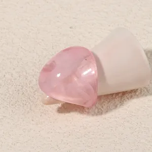 Detailed shot of a stylish pink acrylic geometric ring, minimalist resin finger ring.