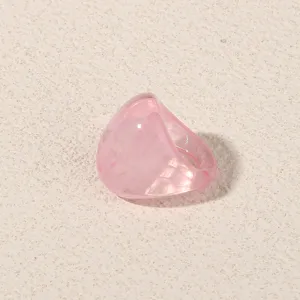 Pink translucent acrylic geometric ring detail view, minimalist fashion finger jewelry.