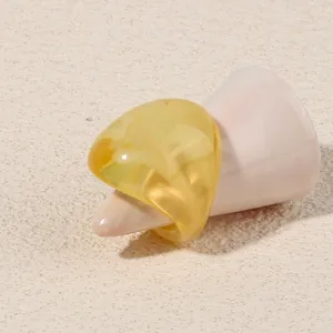 Detailed shot of a stylish yellow translucent acrylic geometric ring, minimalist design jewelry.