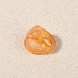 Orange acrylic ring detail shot, minimalist geometric resin finger jewelry for women daily wear.
