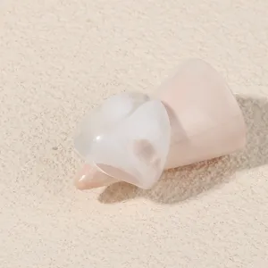 Close-up view of minimalist geometric acrylic ring detail, showing smooth resin texture and design.
