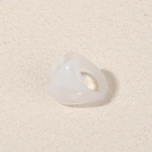 Detailed shot of a minimalist geometric translucent white acrylic ring for women fashion style.