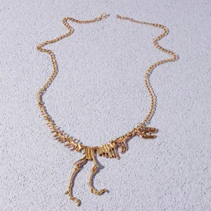 Gold dinosaur skeleton pendant necklace with fine chain for women fashion jewelry detail view.