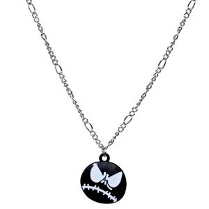 Detailed close-up of the black and white skull pendant on a silver necklace chain.