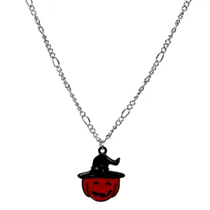 Close-up detail of the Halloween pumpkin witch hat pendant on a silver chain necklace.
