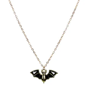 Detailed view of gothic punk style gold tone chain necklace with black white enamel bat pendant.