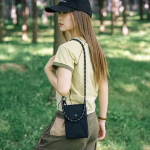 Dettaglio della mini borsa a tracolla nera in tela con tracolla in corda regolabile.
