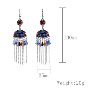 Pendientes colgantes estilo boho de metal con flecos diseño mal de ojo y cristales coloridos.