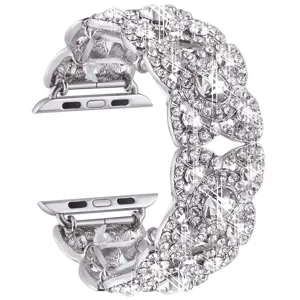 Close-up detail of the sparkling silver rhinestone four-petal flower metal watch strap.