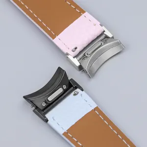 Close-up view of leather watch strap connector and metal folding clasp detail design.