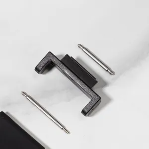 Detail view of black watch strap connector adapter and metal spring bars for modification parts.