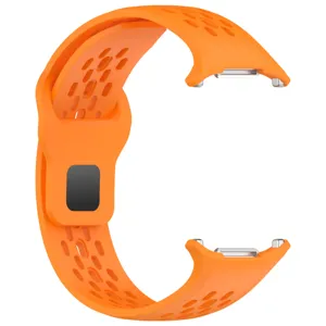 Orange silicone watch strap detail, perforated breathable sport design, metal buckle and loop.