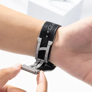 Detailed view of black silicone watch strap with stainless steel folding clasp on wrist.