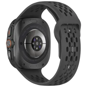 Detailed view of the smartwatch back cover sensor array and perforated silicone sport watch band.